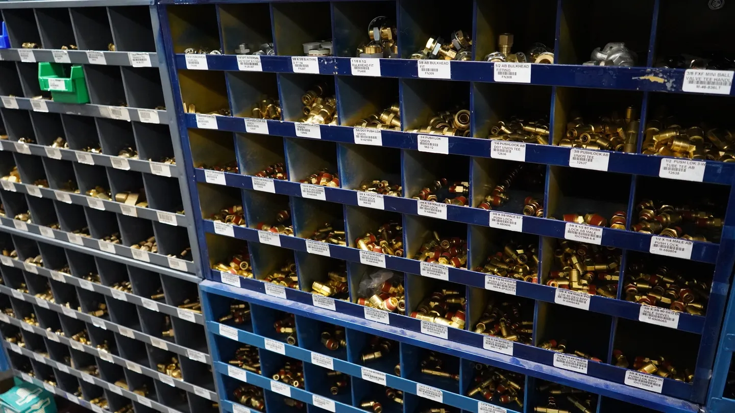 A wall of shelves filled with many different types of nuts.